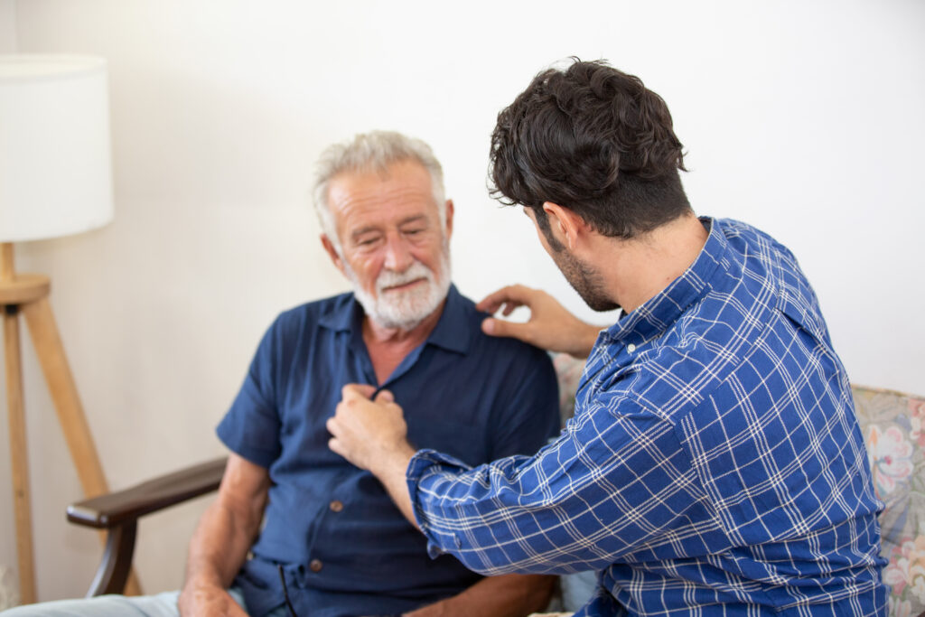 An older man and a younger man sharing a moment at home.